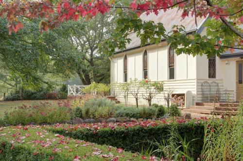 a house with a garden in front of it at The Church at Lyonville - Daylesford Region in Lyonville