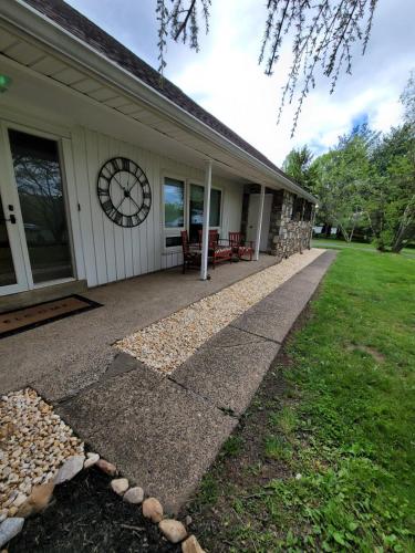 a house with a clock on the side of it at Bridle Pool House in Lansdale