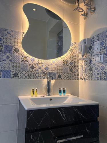 a bathroom with a sink and a mirror at LE Grand Pyramids View & Suites in Cairo