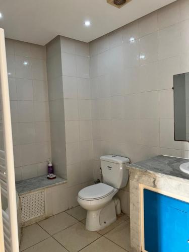 a bathroom with a toilet and a sink at Maison azur in Tunis