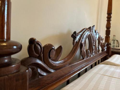 a close up of a wooden bed frame at Santa Maria - A Premium Boutique Homestay by the Sea I Trivandrum Airport 1mile in Trivandrum