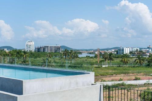 a swimming pool with a view of a city at Con alberca a 10 min de playa - Nerea 303 in Mazatlán