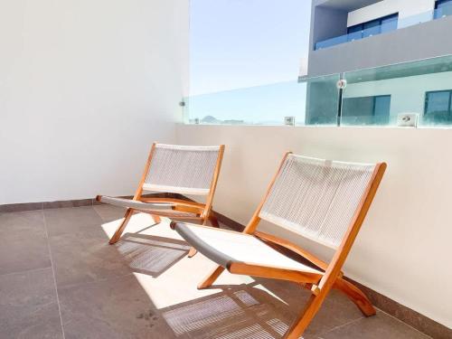 two chairs sitting on top of a roof at Charming apartment 3 minutes from the beach in Mazatlán