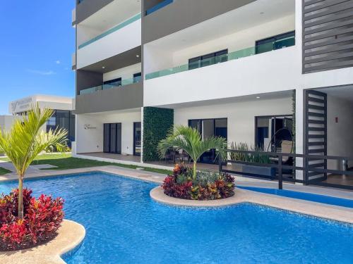 a swimming pool in front of a building at Charming apartment 3 minutes from the beach in Mazatlán