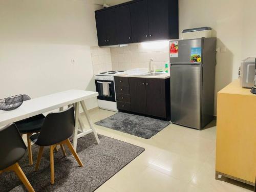 a kitchen with a refrigerator and a table and chairs at Beauty Home Orestiada Center in Orestiada