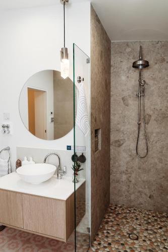 a bathroom with a sink and a mirror at Hollyberry House in Cooma