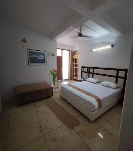 a bedroom with a large bed and a window at Lamyali Farm in Rishīkesh