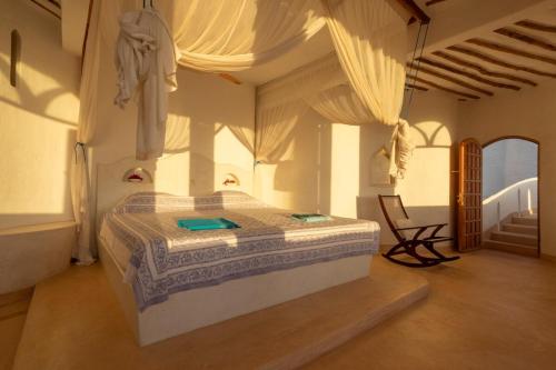 a bedroom with a large bed in a room at Fig House in Takaungu