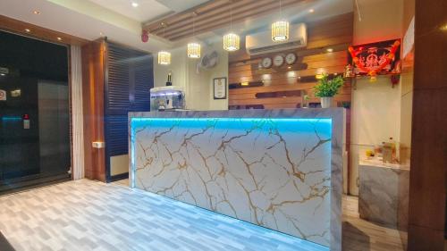 a counter in a kitchen with a marble counter top at Hotel Ashraya International in Mumbai