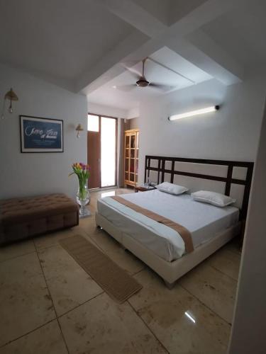a bedroom with a large bed and a window at Lamyali Farm in Rishīkesh