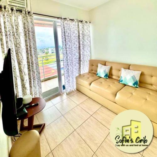 a living room with a couch and a window at Sofia's Crib Primavera Residences in Cagayan de Oro