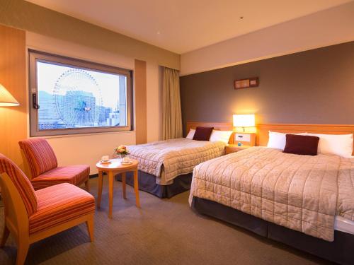 Una cama o camas en una habitación de Navios Yokohama