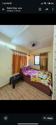 a bedroom with a large bed in a room at Bluestar cottage in Matheran
