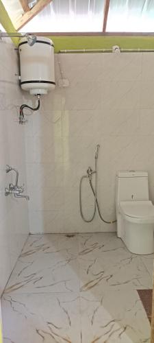 a bathroom with a shower and a toilet at Katus in Gangtok