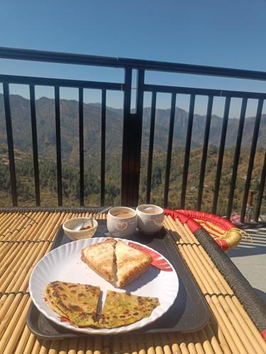 two slices of pizza sitting on a tray on a table at Happy Homestay And Rooftop cafe in Chamba