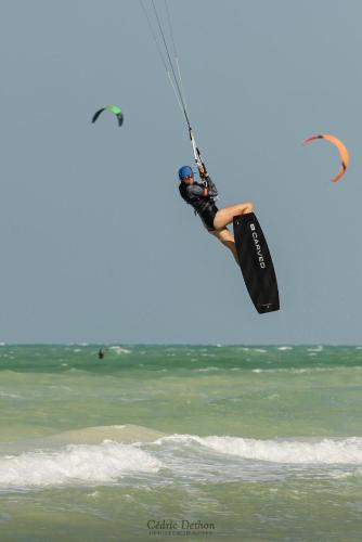 a person on a board in the air over the ocean at Casita viento in El Cuyo