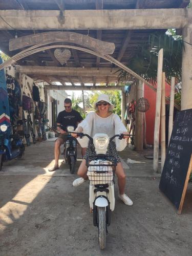 a woman is sitting on a motor bike at Casita viento in El Cuyo