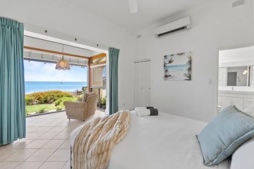 a living room with a bed and a view of the ocean at Belle Escapes - Ocean Breeze Family Villa in Somerton Park