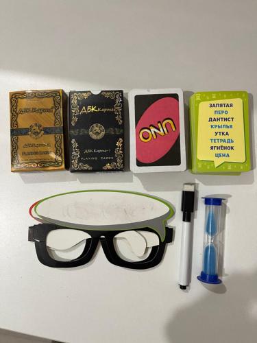 a pair of glasses and other items on a table at Уютная 2-х комнатная квартира in Taraz