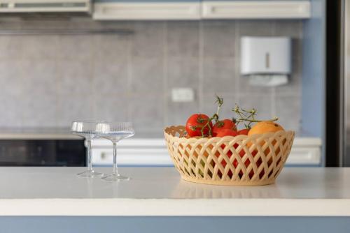 a basket of fruit on a counter with two wine glasses at Devon Meadows Farm Escape in Devon Meadows