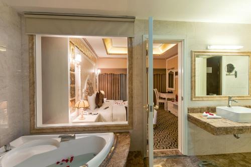 ein Badezimmer mit einer Badewanne und einem Waschbecken in der Unterkunft Muong Thanh Luxury Song Lam Hotel in Vinh