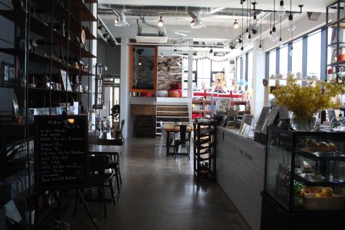a restaurant with tables and chairs in a room at Andong Poong-gyung HOSTEL n LIBRARY in Andong
