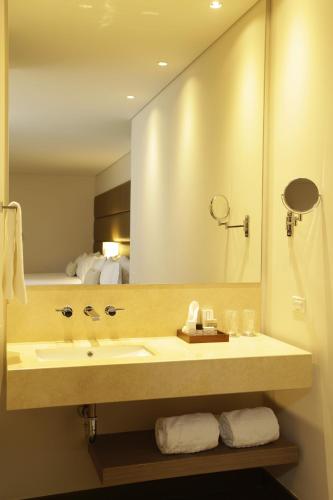 a bathroom with a sink and a large mirror at bs Rosales Hotel in Bogotá
