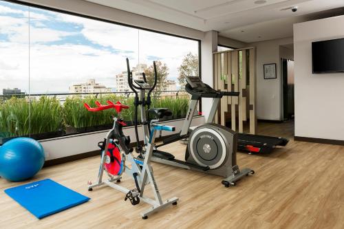 a fitness room with a gym with a large window at bs Rosales Hotel in Bogotá