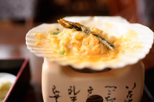 a bowl of food on top of a table at Suigunnoyado in Ajigasawa