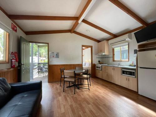a kitchen and living room with a table and chairs at BIG4 Yarra Valley Park Lane Holiday Park in Healesville