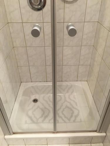 a shower with a glass door in a bathroom at Haus Walser in Tarrenz
