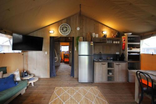 a kitchen and living room with a refrigerator in a room at BIG4 Yarra Valley Park Lane Holiday Park in Healesville