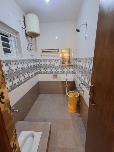 a bathroom with a tub and a sink at A N S Residency in Ooty