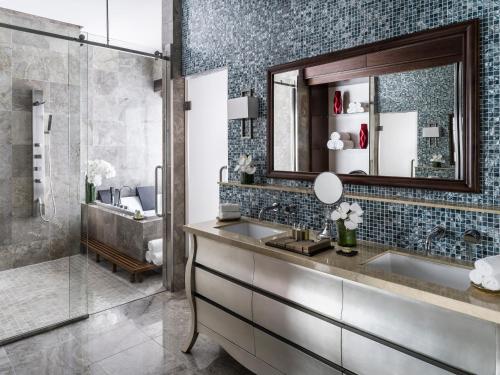 a bathroom with a sink and a shower at Dusit Thani Guam Resort in Tumon