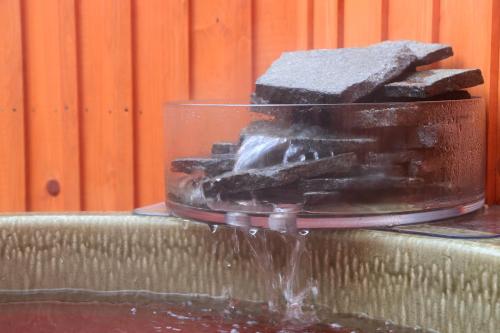 a close up of a water fountain with rocks at Minshuku Murou in Uda