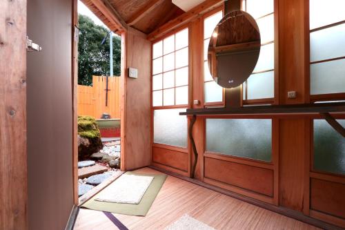 a room with windows and a television and a door at Minshuku Murou in Uda
