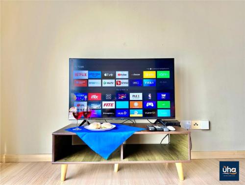 a flat screen tv sitting on top of a table at Austin Cube 8 Teens by RR JBcity in Johor Bahru