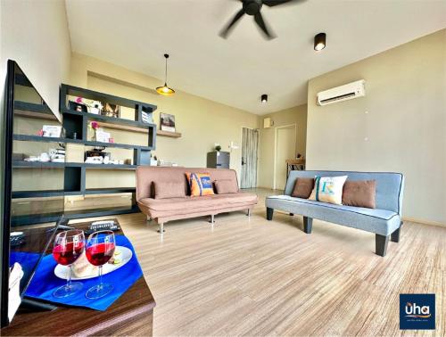 a living room with two couches and two glasses of wine at Austin Cube 8 Teens by RR JBcity in Johor Bahru