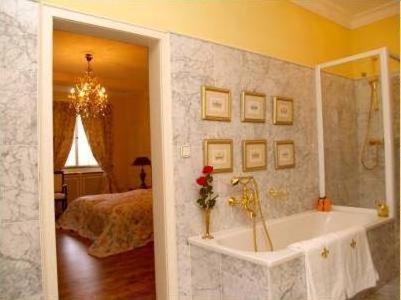 a bathroom with a tub and a bedroom with a bed at Bastgen Bed & Breakfast in Wittlich