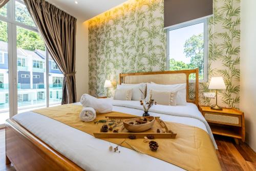 a bedroom with a large bed with a large window at La Ferringhi Villa - Tropical Collection, by ALV in Batu Ferringhi