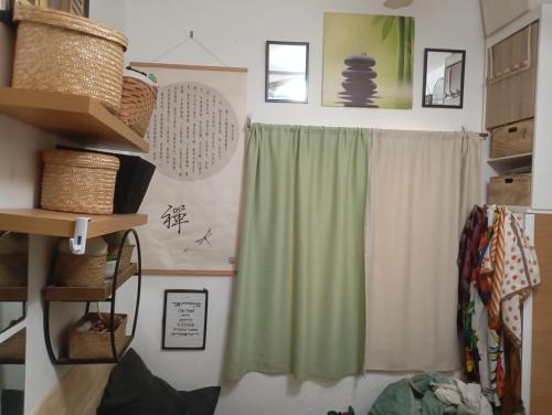 a room with a window with a green curtain at Garden Apartment Bnai Brak in Bene Beraq