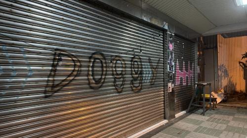 a metal garage door with the word eviction written on it at HappyHealingHeaven in Hengchun
