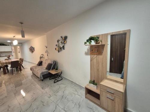 a living room with a couch and a mirror at 3BR Family Stay Near Valletta in Hamrun