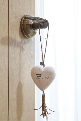 a heart shaped keychain hanging on a door at Hotel Es Marès in Sant Francesc Xavier