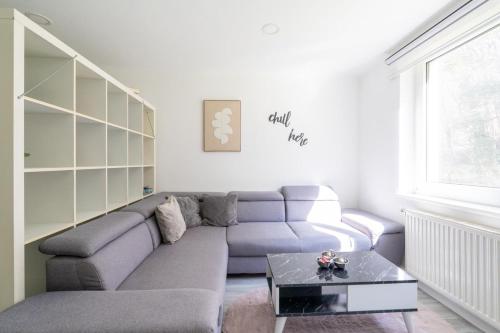 a living room with a couch and a coffee table at Natur View Apartment in Kaltenleutgeben