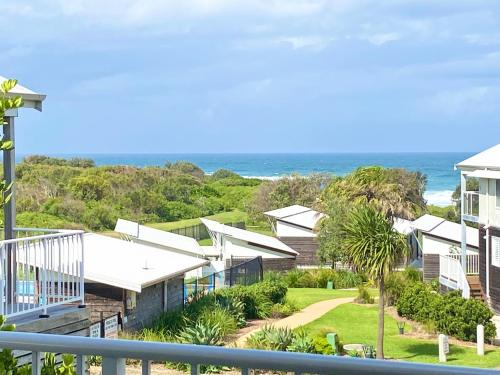 a view of the ocean from the balcony of a house at Aqua Villa at Caves Beach Villas in Caves Beach