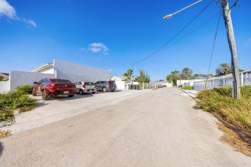 a street with cars parked in a parking lot at Charming 2 BR Oasis in Oranjestad by Bocobay in Pos Abao