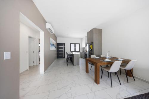 a kitchen and dining room with a table and chairs at Charming 2 BR Oasis in Oranjestad by Bocobay in Pos Abao