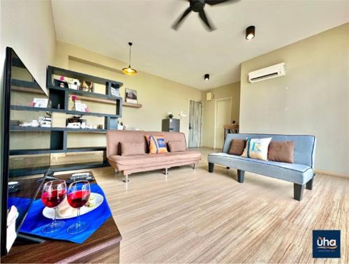 a living room with two couches and wine glasses on a table at Austin Cube 8 Teens by RR JBcity in Johor Bahru