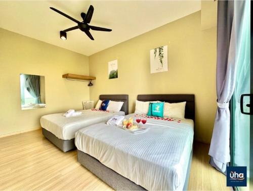 a bedroom with two beds with a ceiling fan at Austin Cube 8 Teens by RR JBcity in Johor Bahru